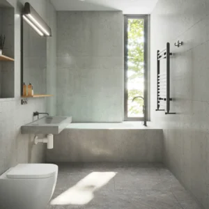 Desain interior kamar mandi minimalis modern bernuansa semen abu-abu dilengkapi wastafel gantung, bathtub, dan pencahayaan alami dari jendela. Gambar ini berada dalam artikel "Renovasi Kamar Mandi Minimalis" di website Ecotown.id